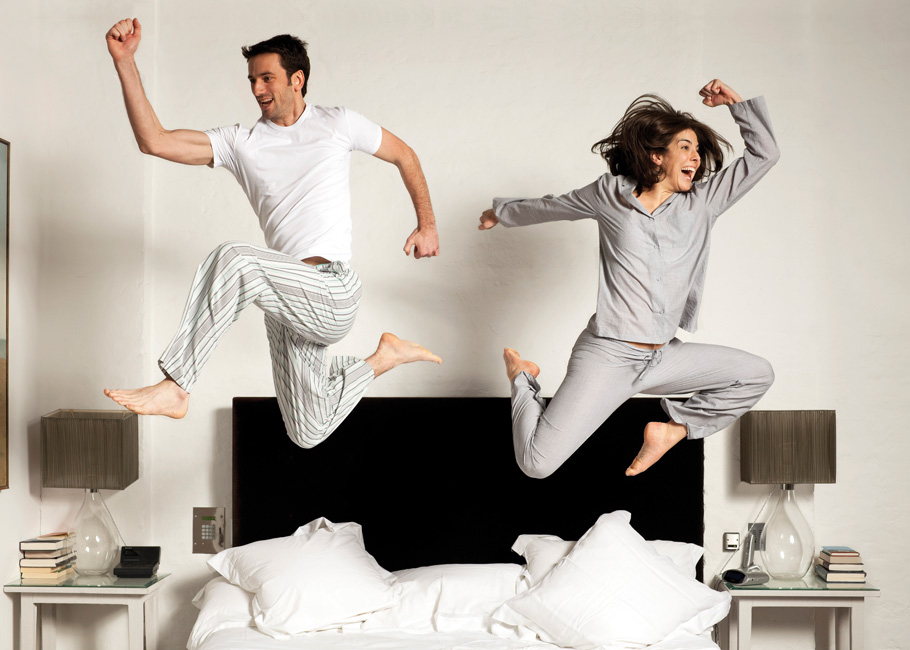 Couple leaping out of bed